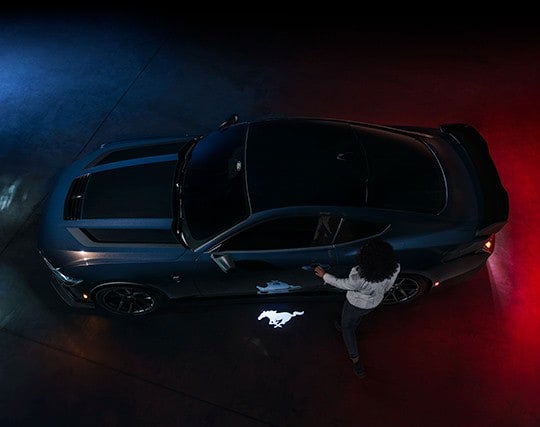 2024 Ford Mustang® Dark Horse™ model with a driver approaching the vehicle | Crow-Moddie Ford in Burlington KS