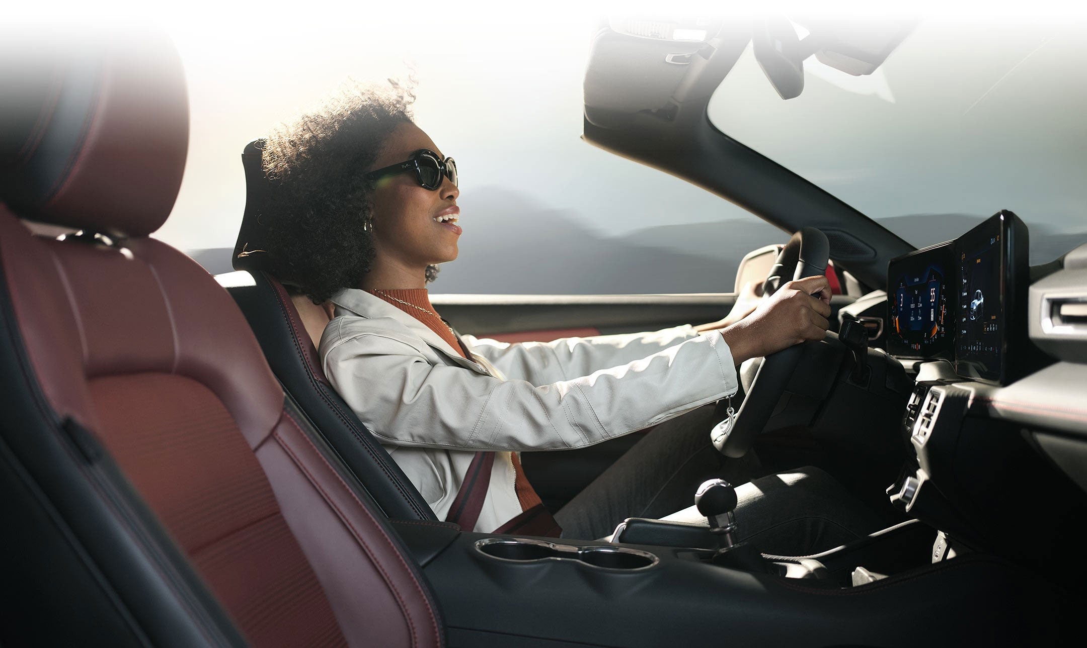 Person sitting in the driver’s seat of a 2024 Ford Mustang® convertible | Crow-Moddie Ford in Burlington KS